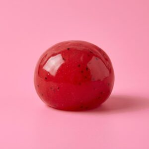 Red watermelon slush ball squishy with black seeds